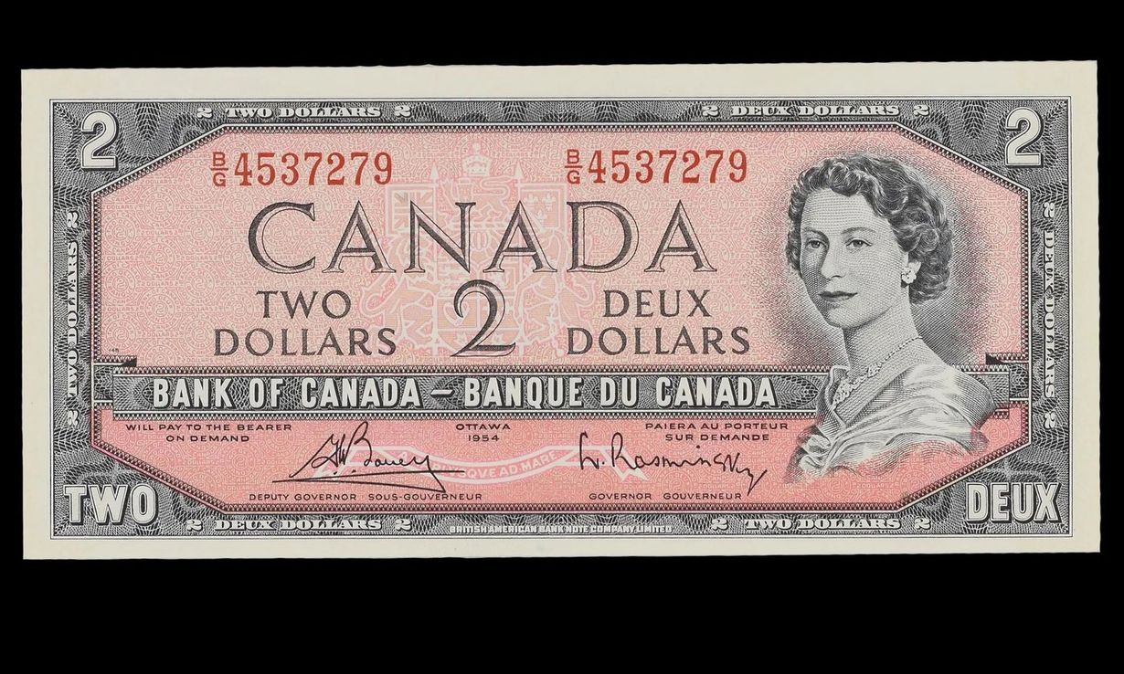 Canadian two-dollar bill with Queen Elizabeth II portrait, pink and black design, bilingual text.