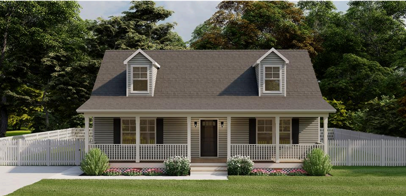 Front view of a small gray house with a porch, dormer windows, and a white fence.