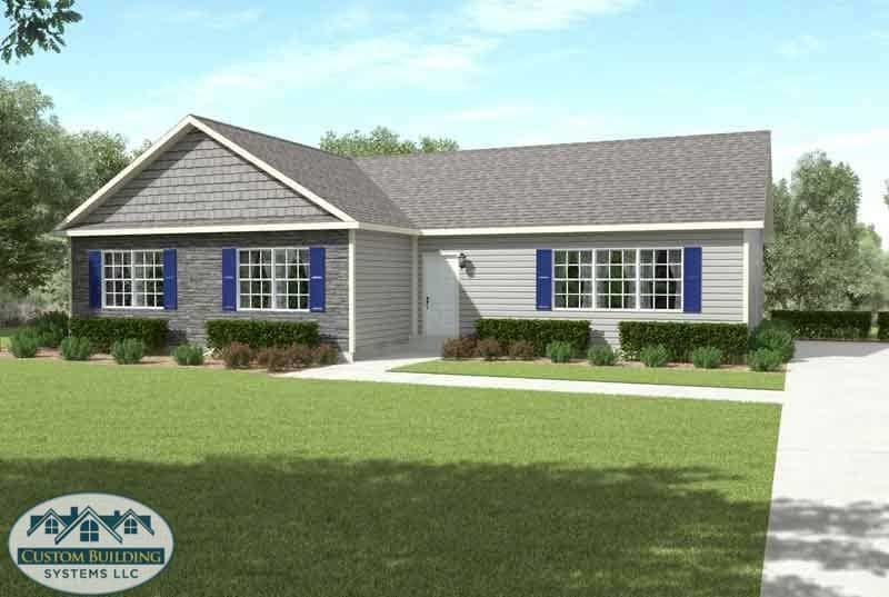 A gray house with blue shutters and a white door, set on a green lawn.