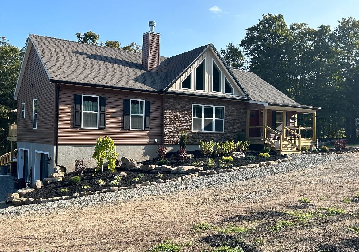 Rustic house with a wooden facade, dark roof, and a stone walkway.