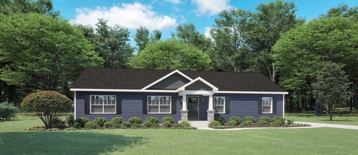 A single-story blue house with a dark roof and a small covered porch, surrounded by green trees and a grassy lawn.