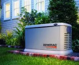 Gray Generac home generator in front yard next to a house with blue siding.