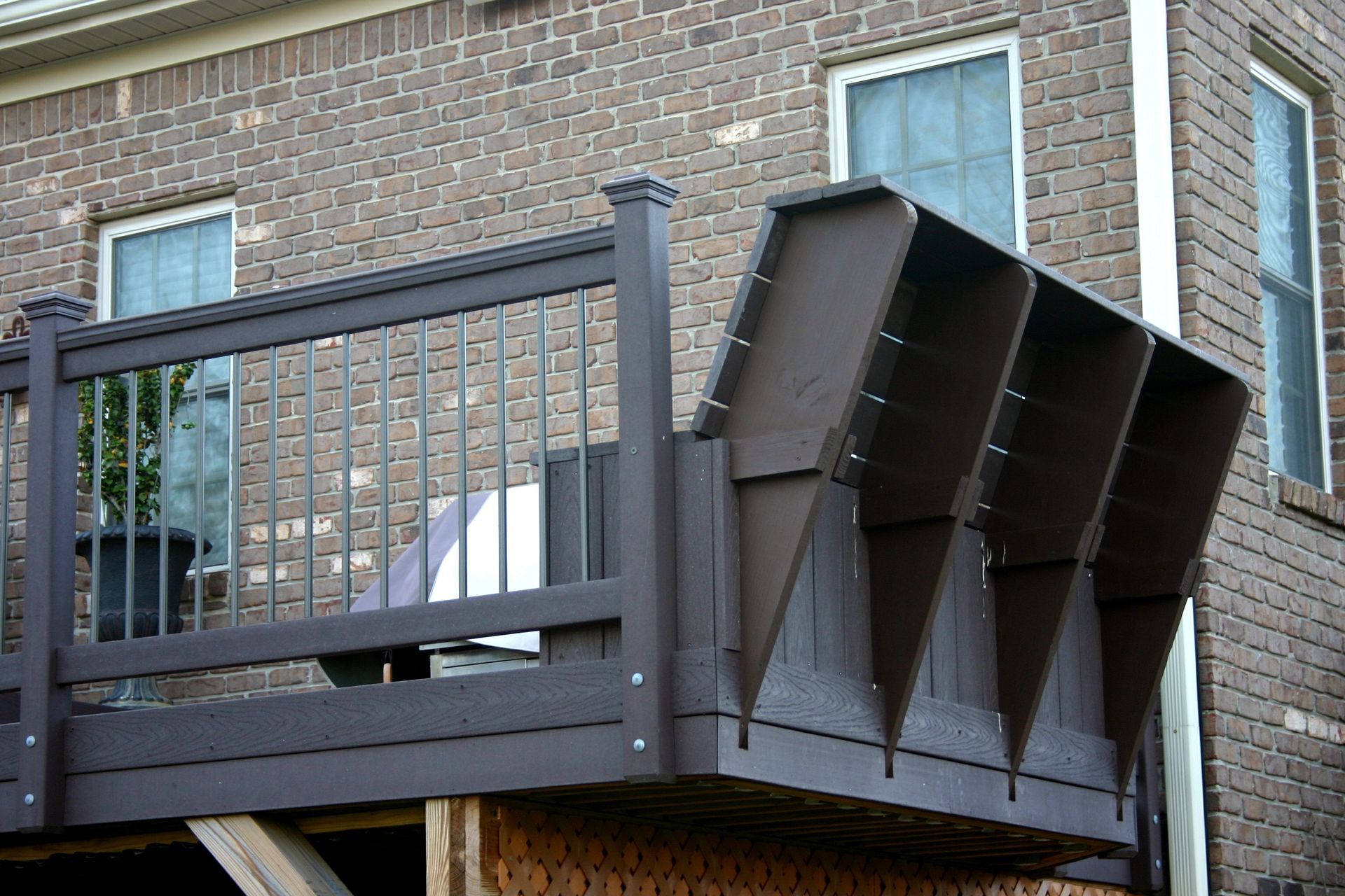 A brick building with a wooden deck in front of it