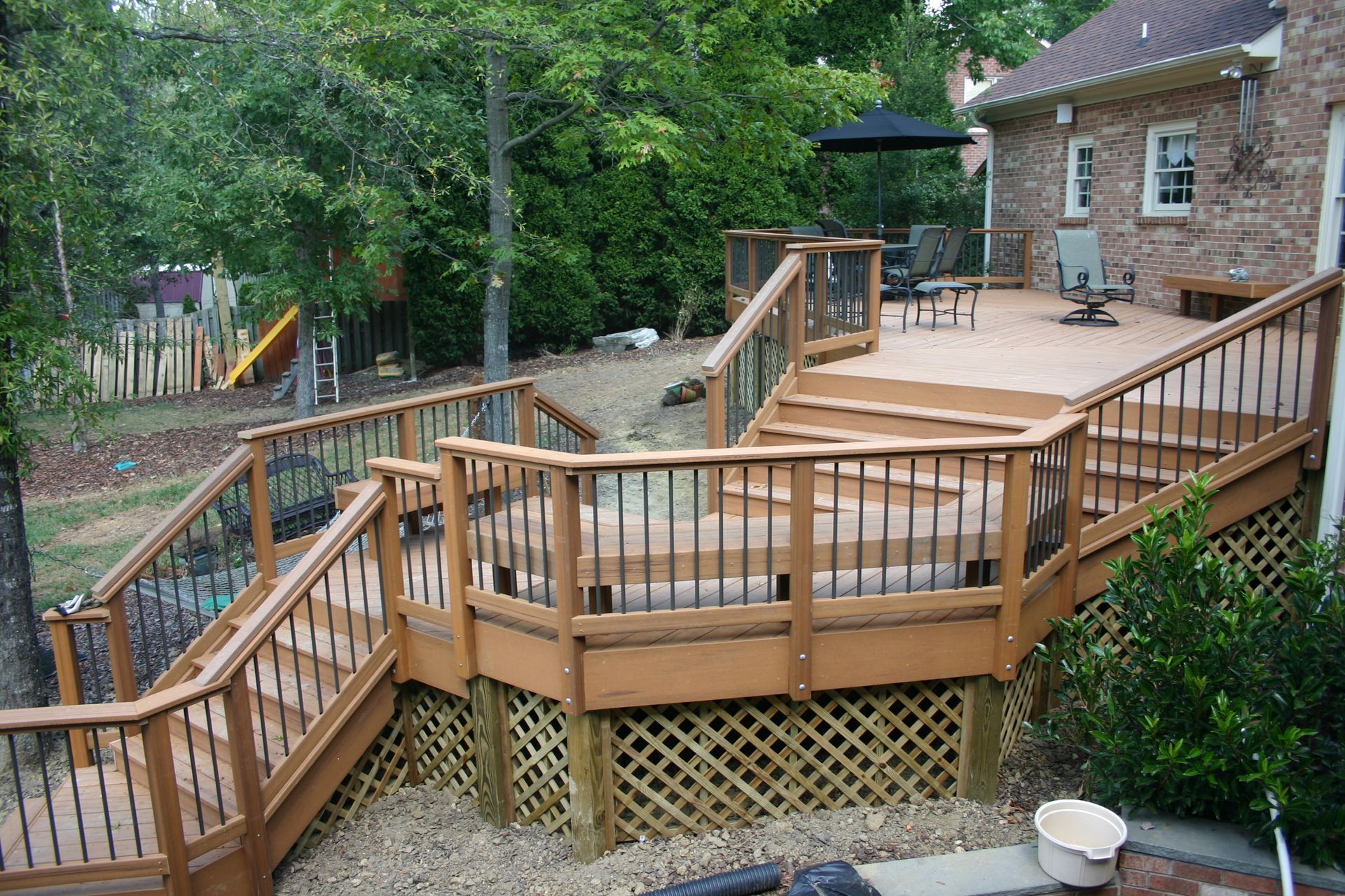 A large wooden deck with stairs leading up to it