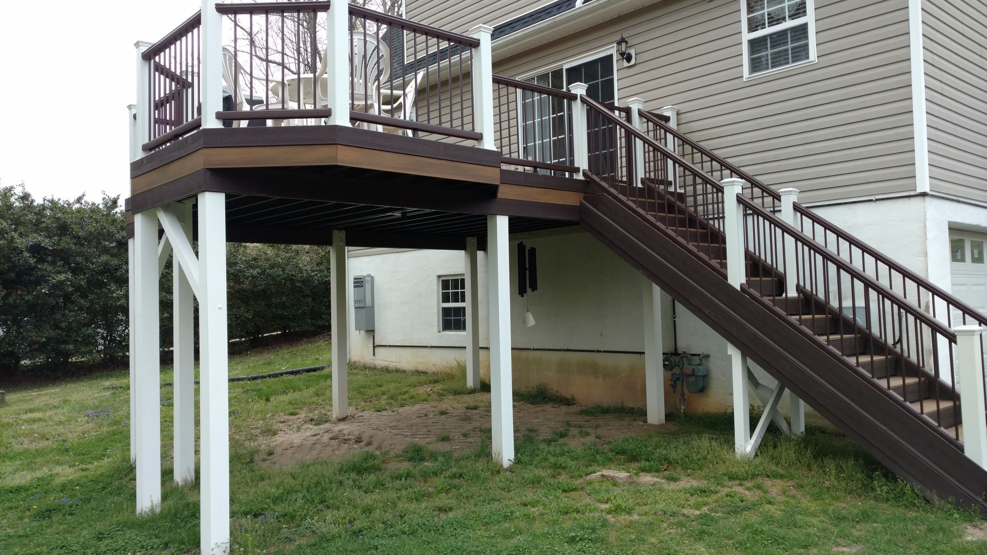 A house with a deck and stairs leading up to it