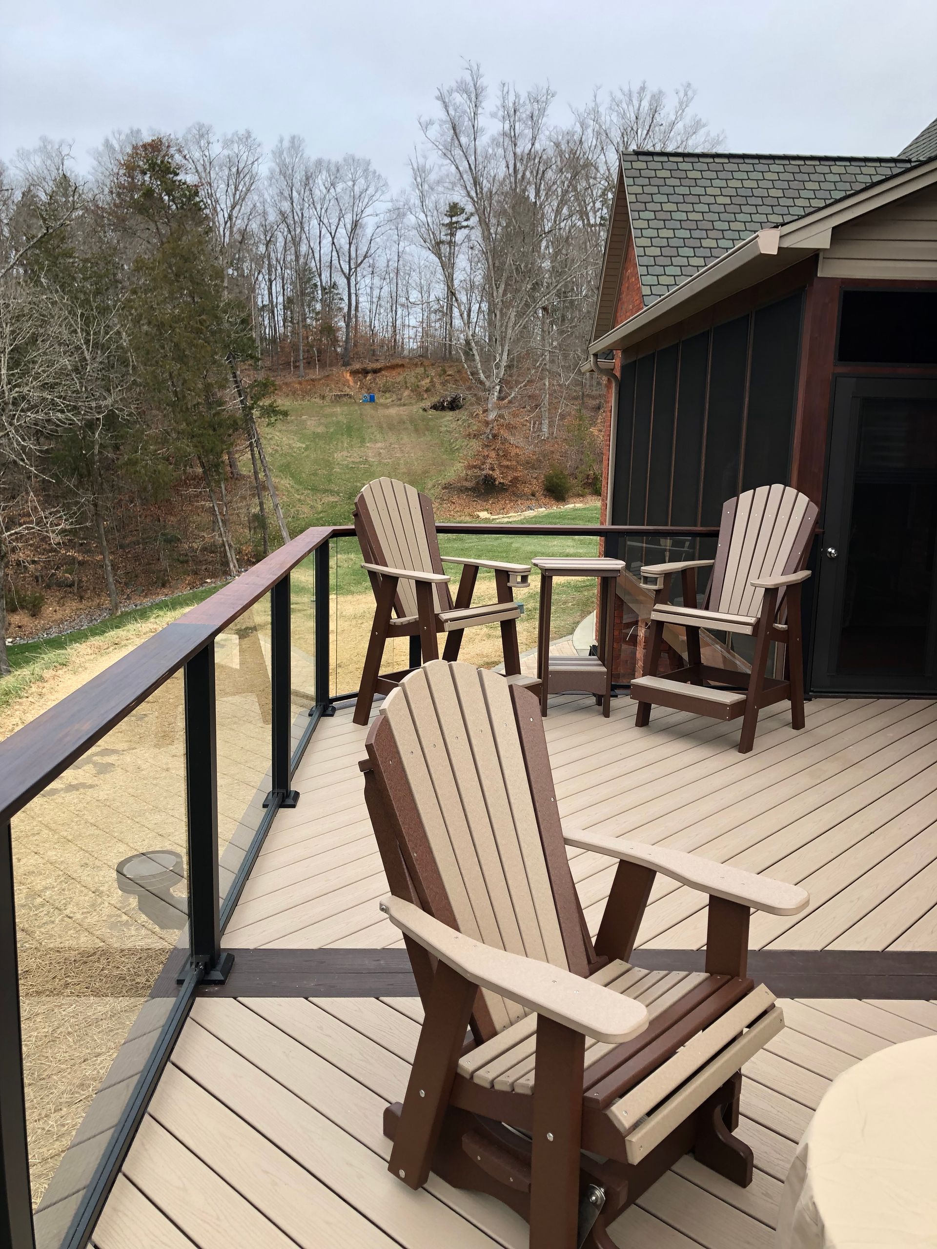 A deck with chairs and a table on it