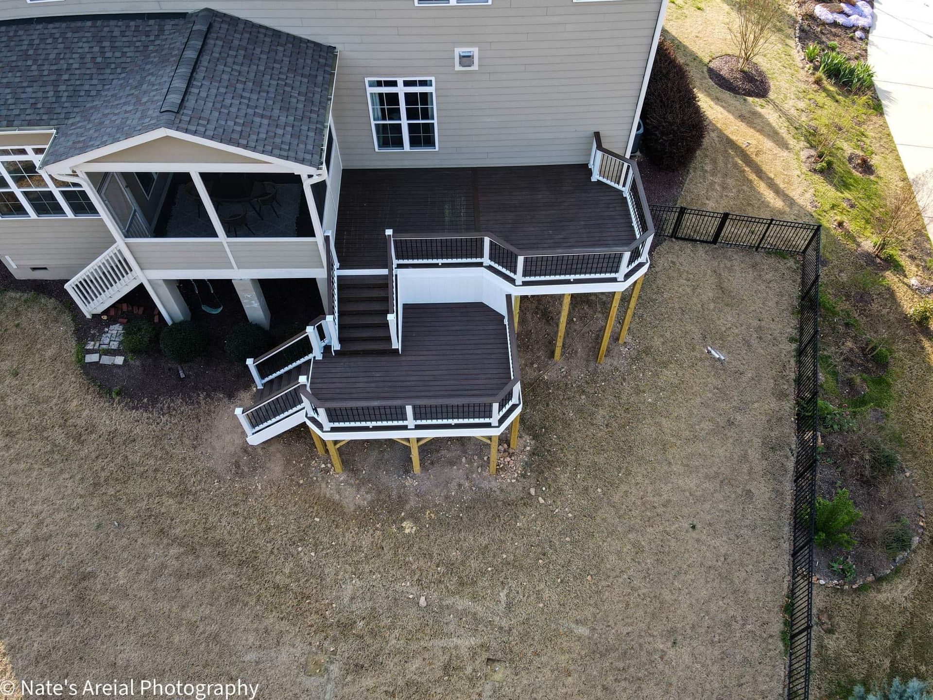 An aerial view of a house with a large deck.