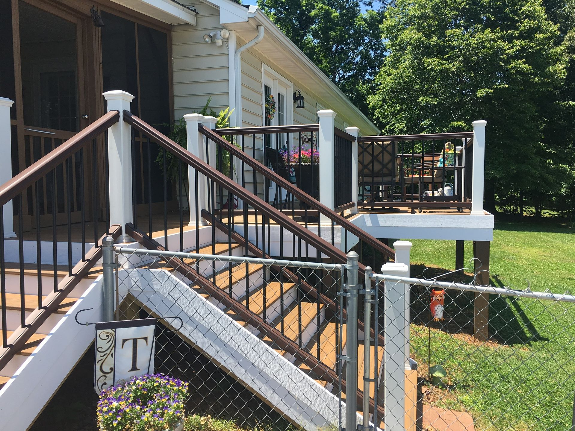 A house with a screened in porch and stairs leading up to it