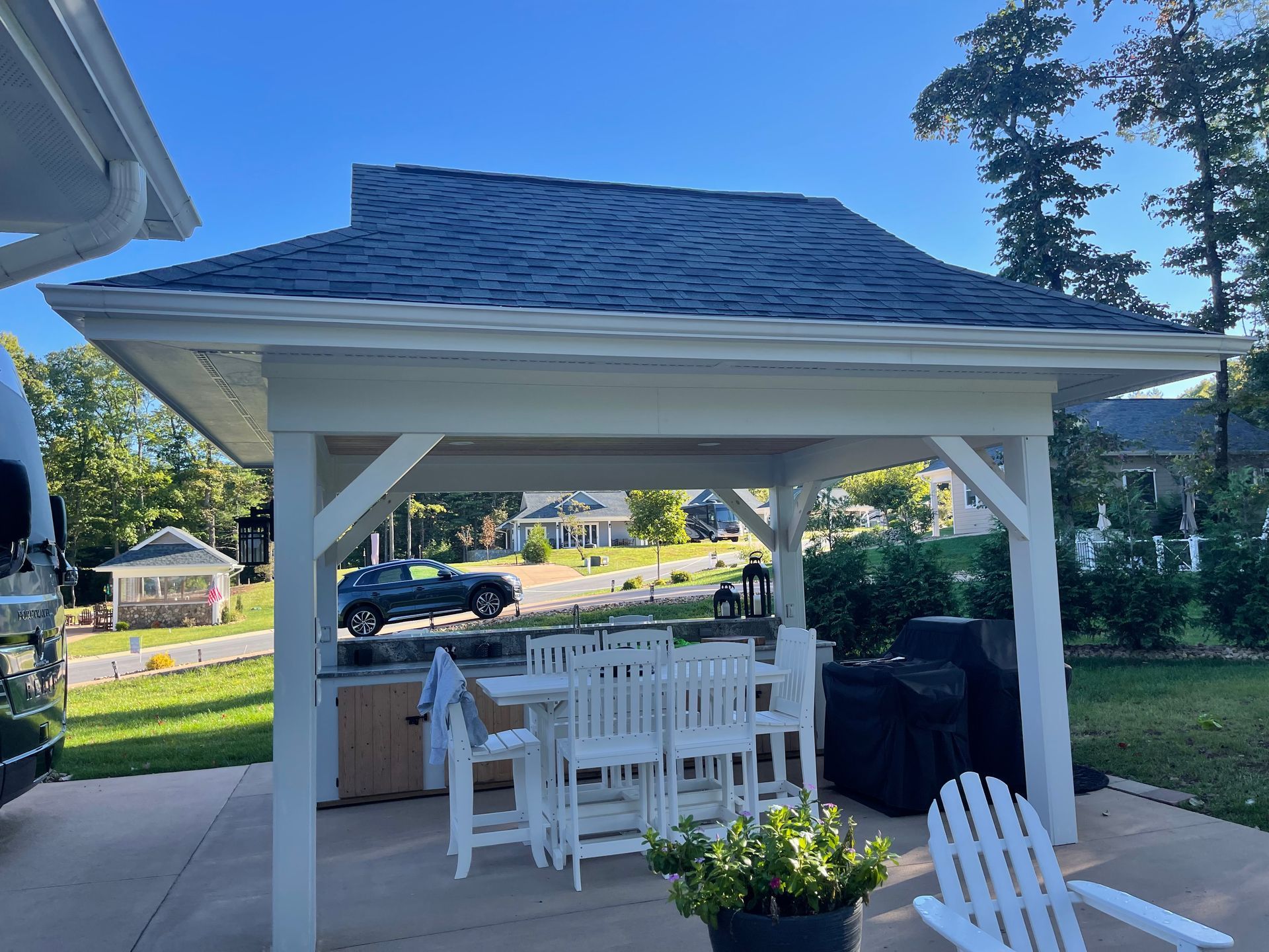 There is a gazebo with a table and chairs underneath it.