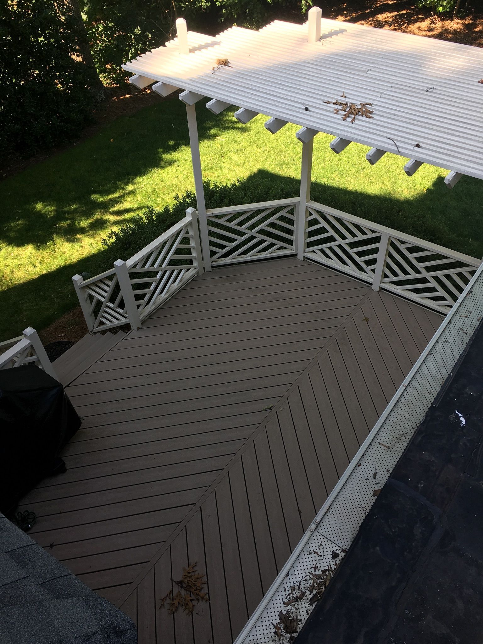 An aerial view of a deck with a pergola over it
