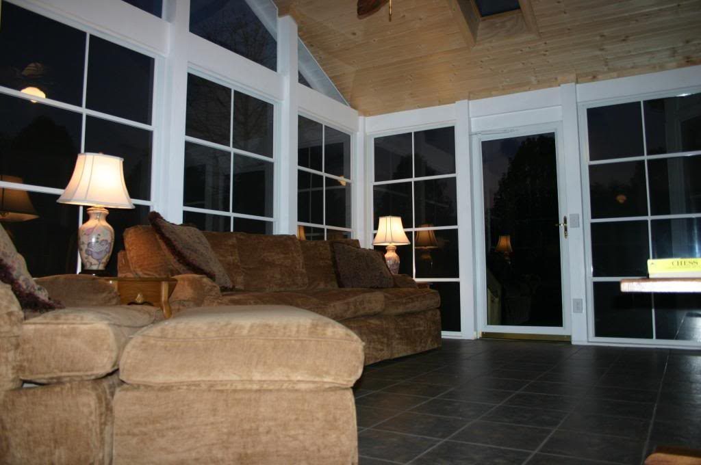 A living room with a couch ottoman and lamps