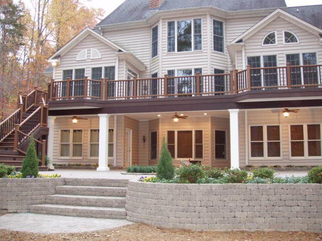 A large house with a large deck and stairs