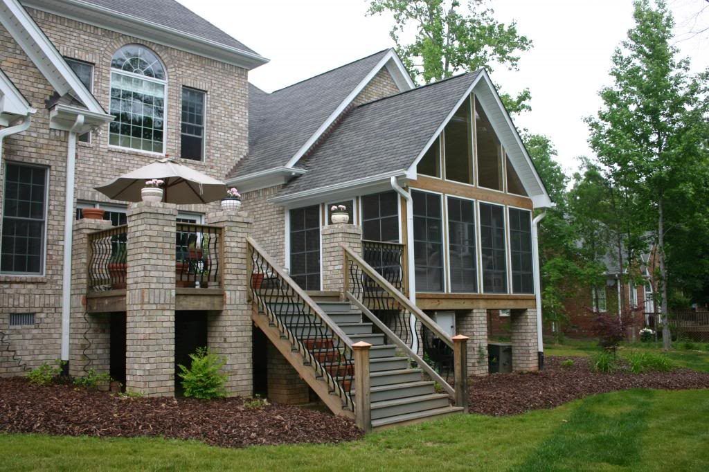 A house with a screened in porch and stairs