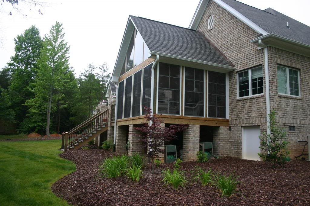 A large brick house with a screened in porch