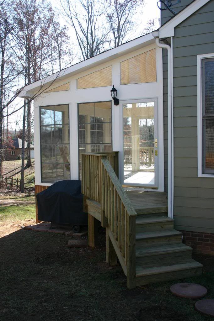 A screened in porch with stairs leading up to it