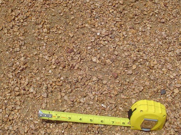 Rotten Granite, chips down to fines 2,800 lbs. per cu yd 115 sq ft @ 2