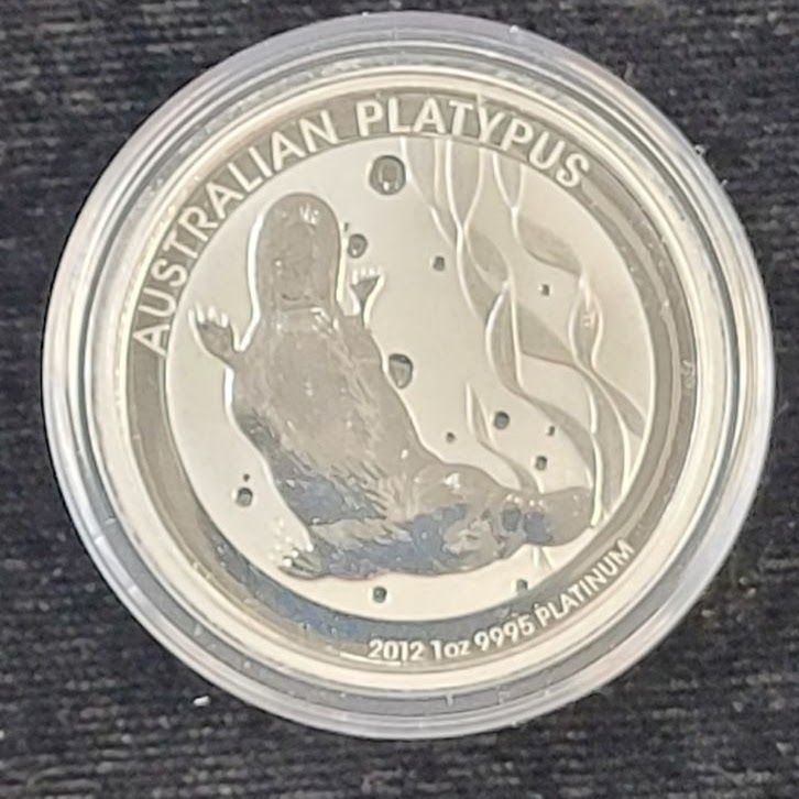 Silver coin with a platypus swimming underwater; reads 