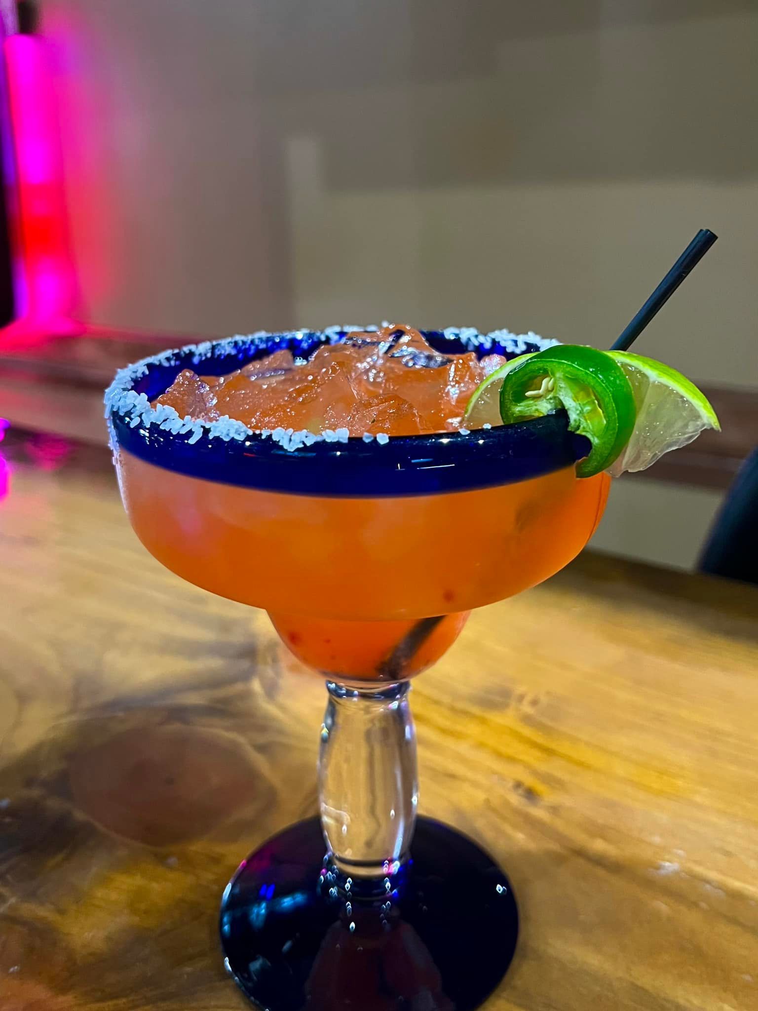 A close up of a margarita in a glass on a table.