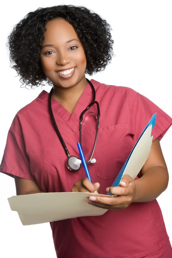 Happy nurse charting or writing a document