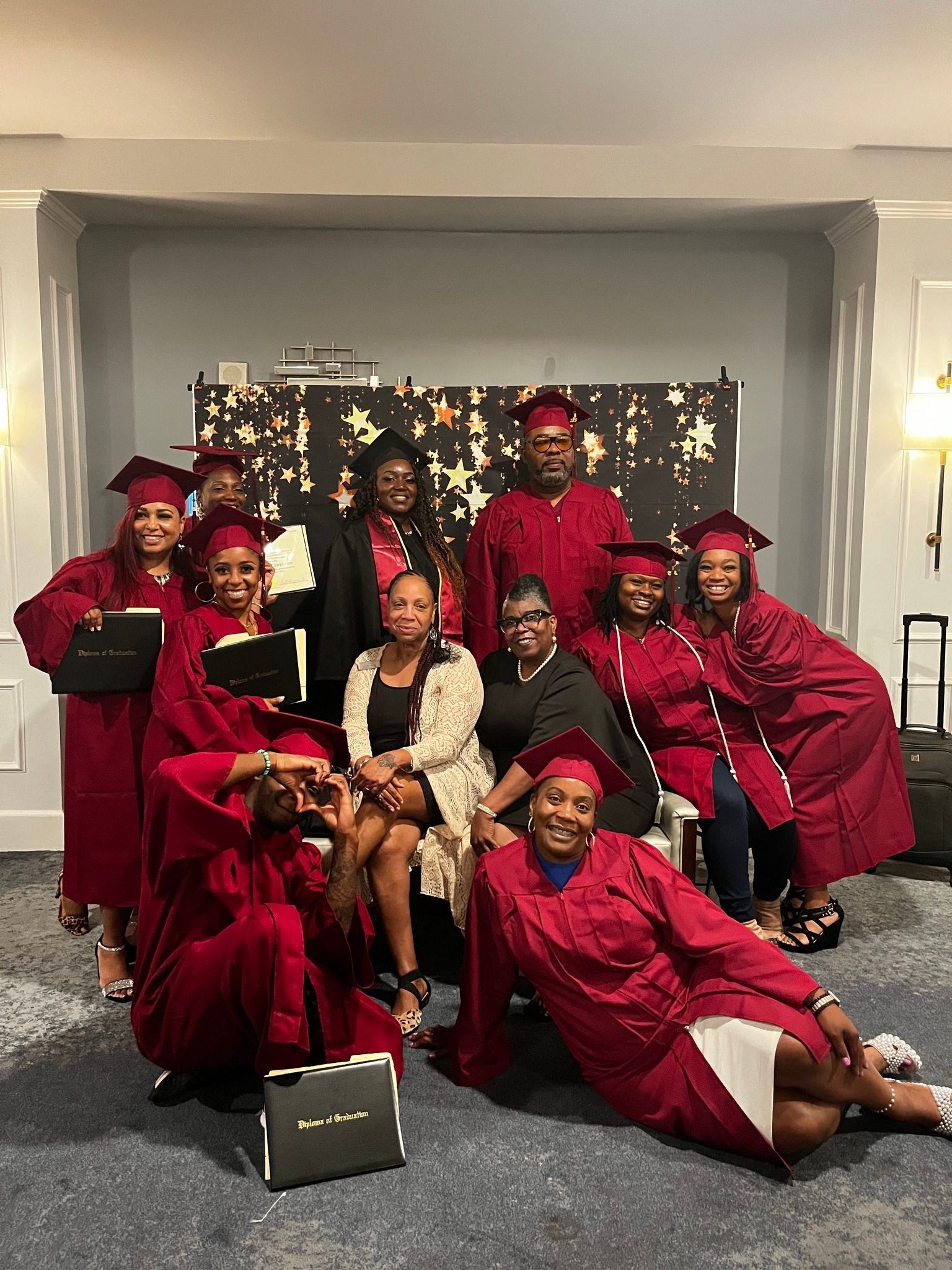 A group of graduates are posing for a picture together.