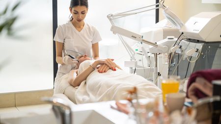 A woman is getting a facial treatment at a spa.