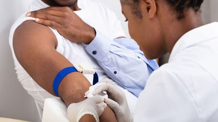 A man getting shot by a needle.