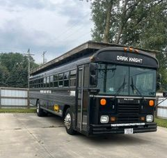 Dark knight party bus all black front view