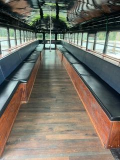 Inside view of party bus with wooden benches with leather tops