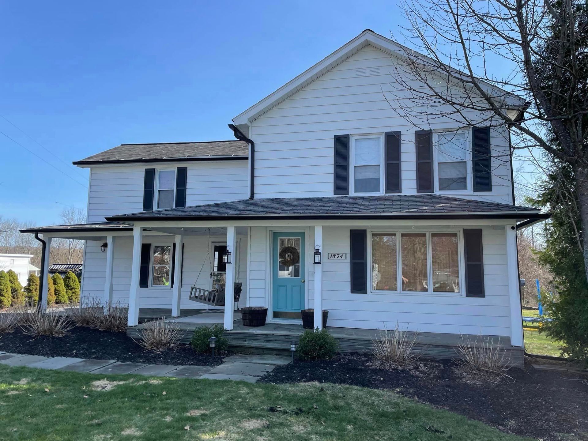 white house with a black gutter -front view