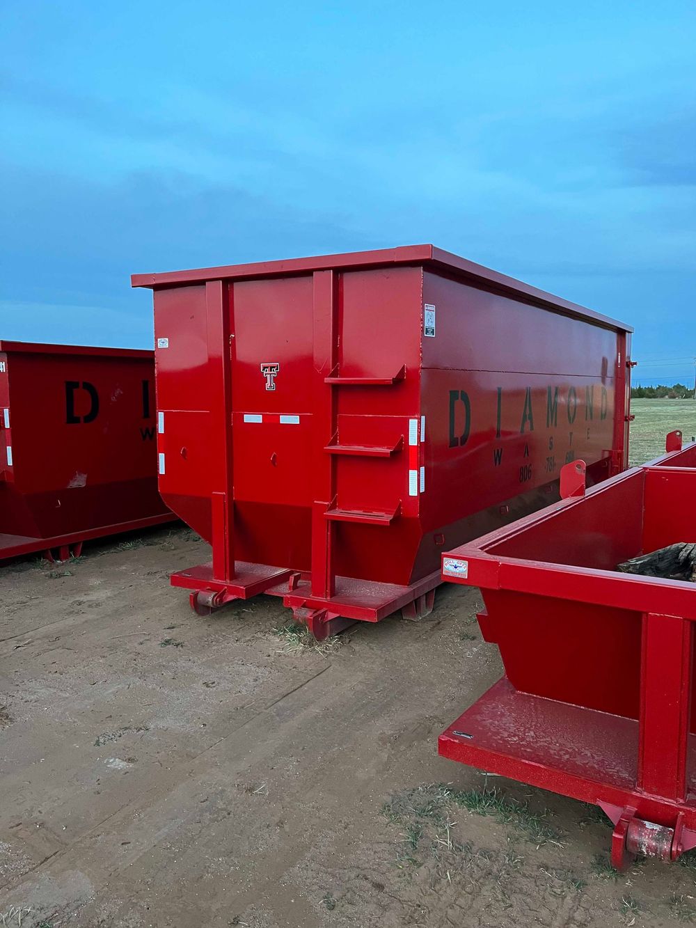 A red dumpster with the letter d on it