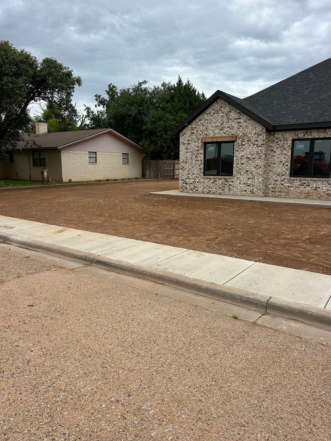 A residential yard that has been recently leveled and cleaned.