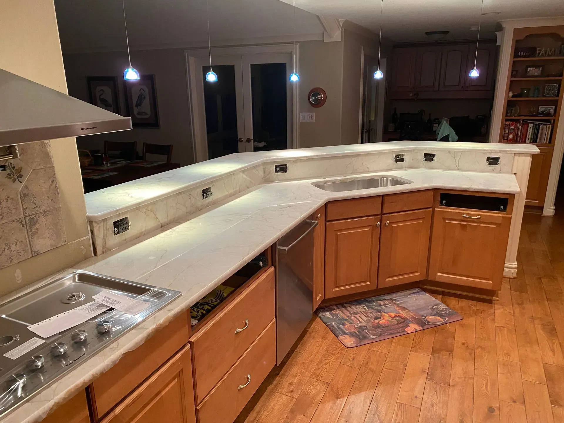 Kitchen with light-colored countertops, wood cabinets, and stainless steel appliances.