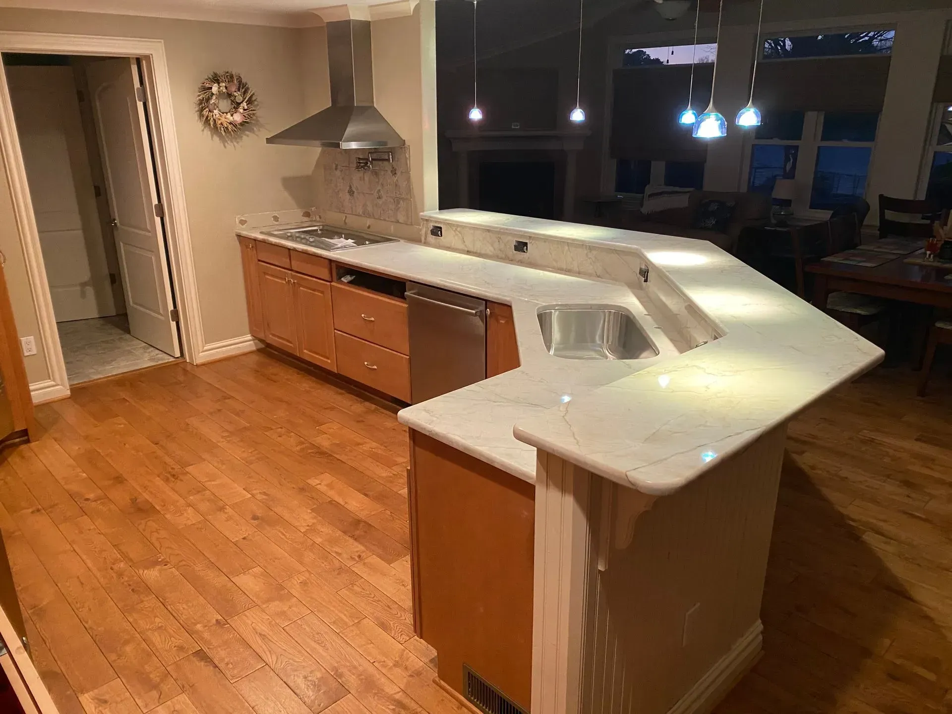 Kitchen with wooden cabinets, light countertops, and stainless steel appliances.
