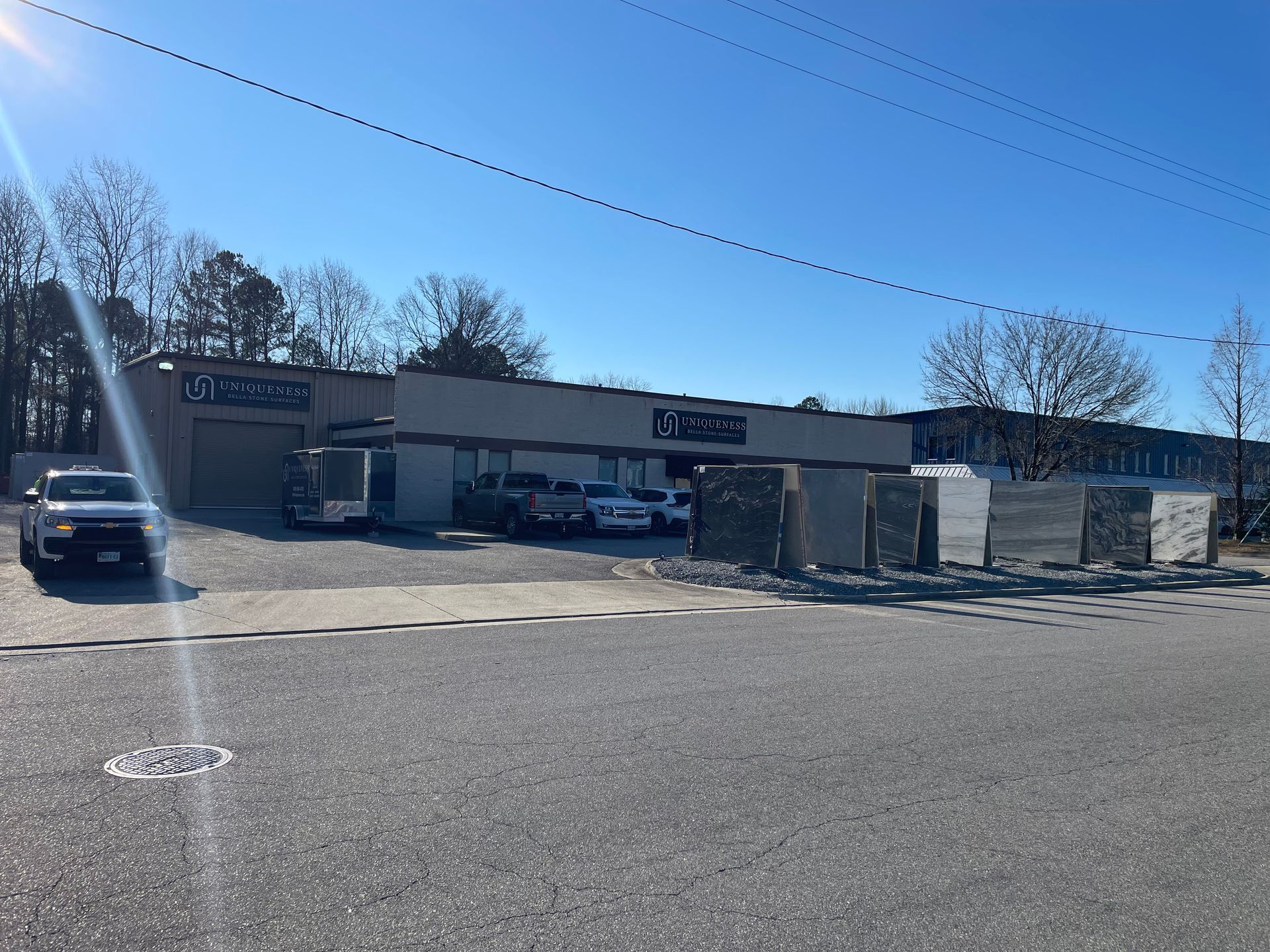 Exterior of a building with a business sign, showcasing building materials outdoors, sunny day.