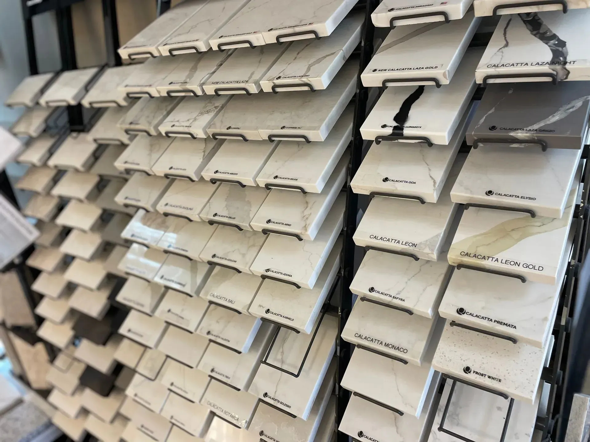 Display of countertop samples in various light colors and patterns.