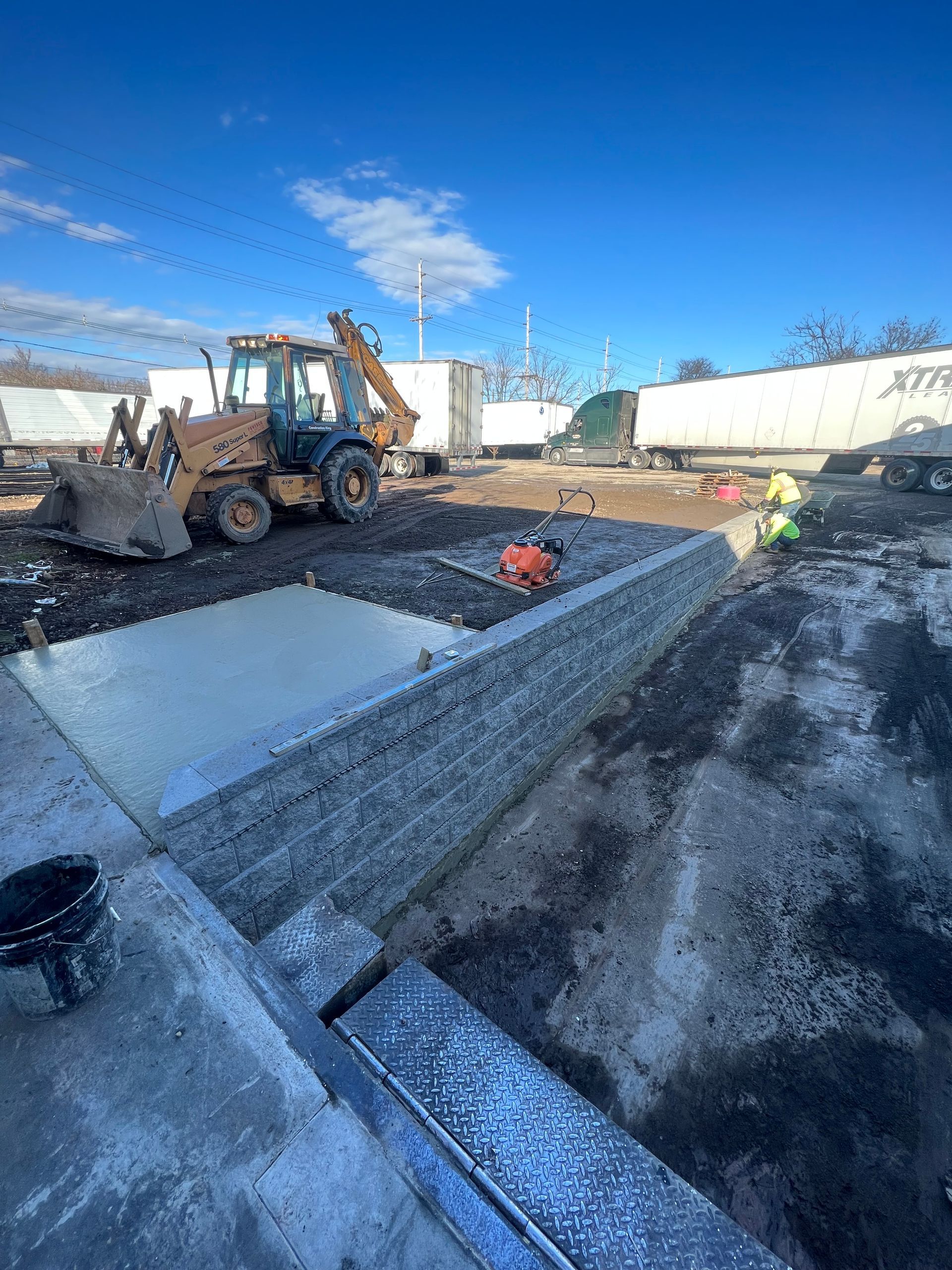 A bulldozer is digging a hole in the ground in a construction site.