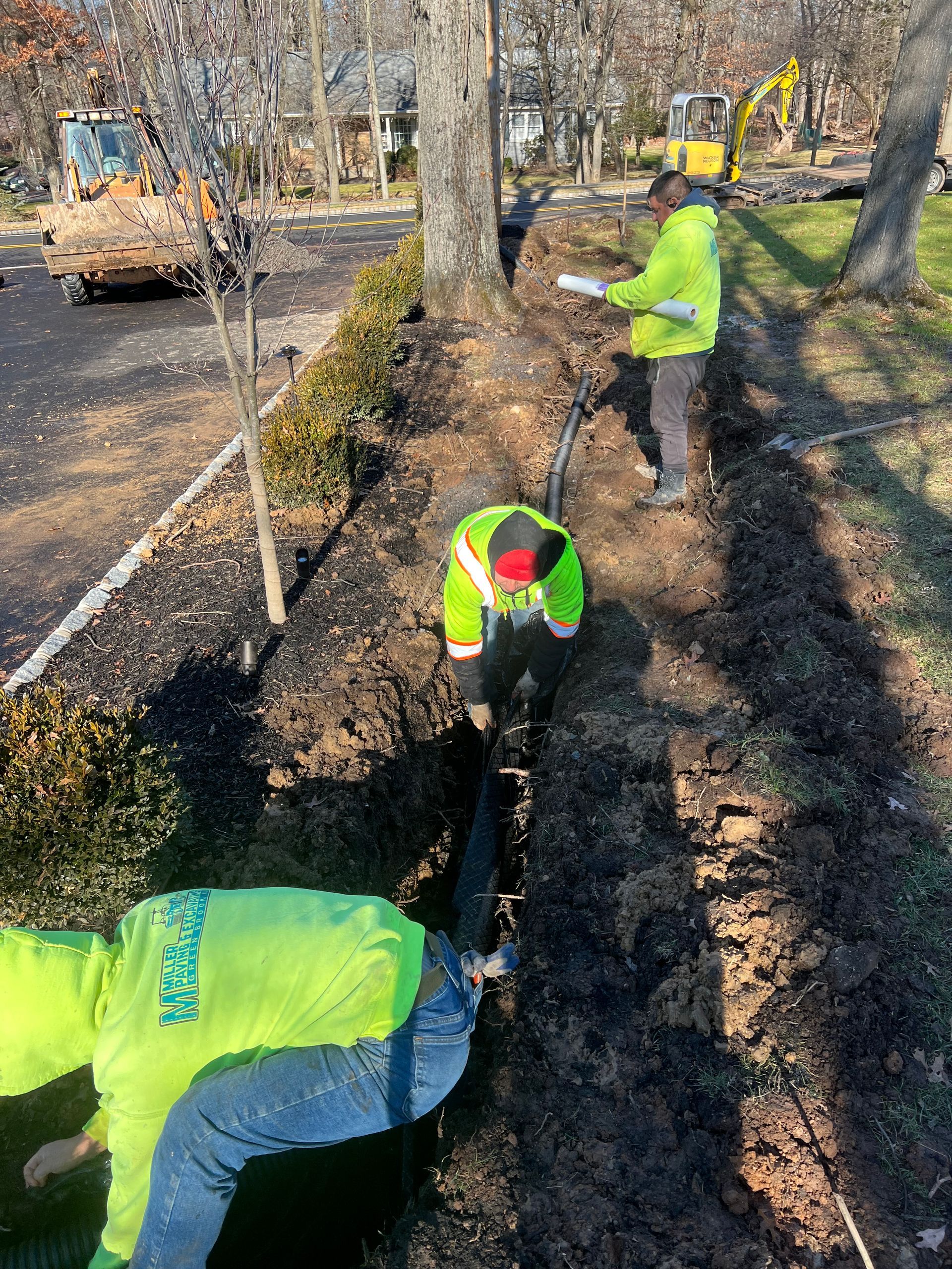 A group of construction workers are digging a hole in the ground.