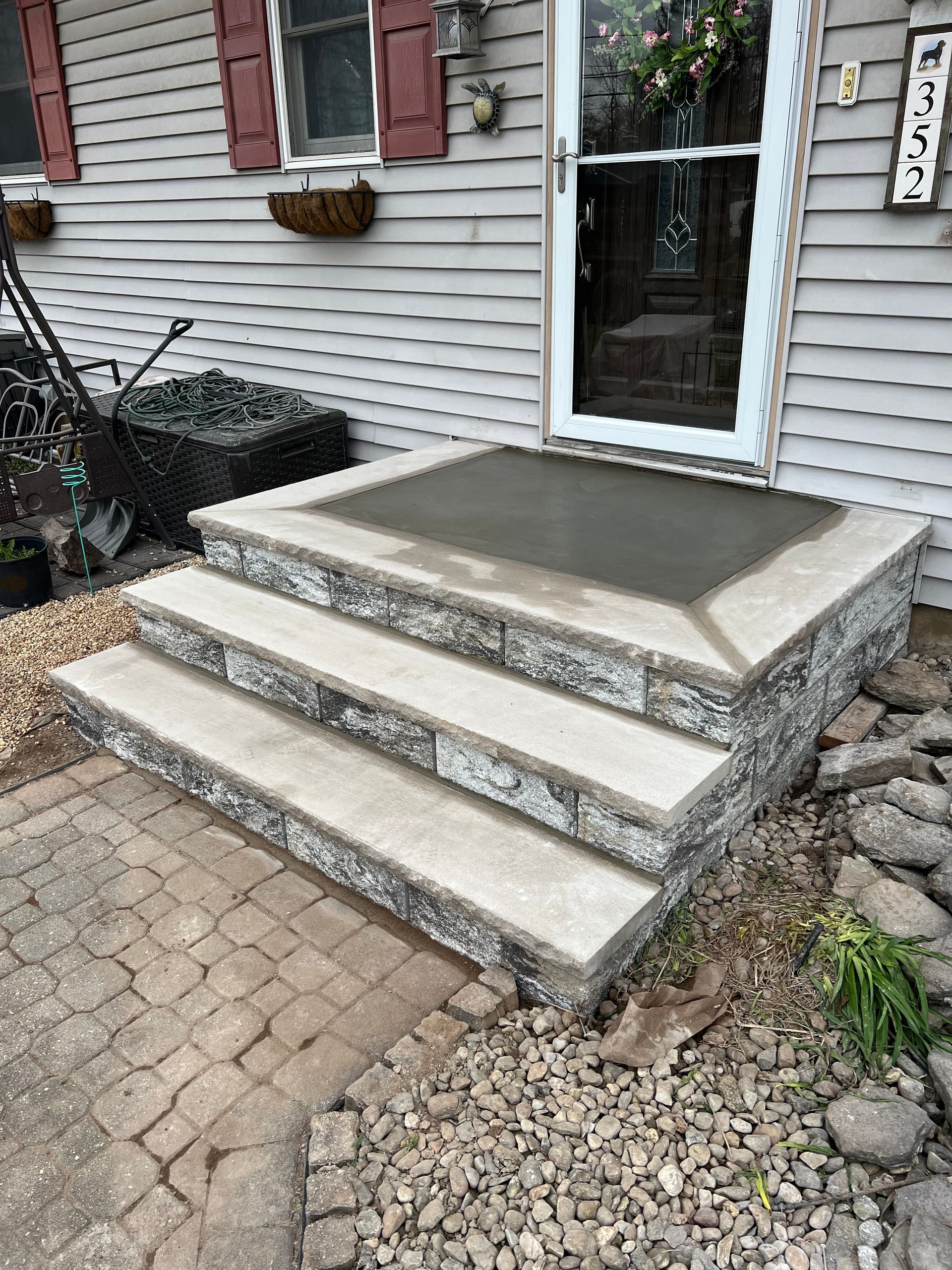 A set of stone steps leading up to a door of a house.