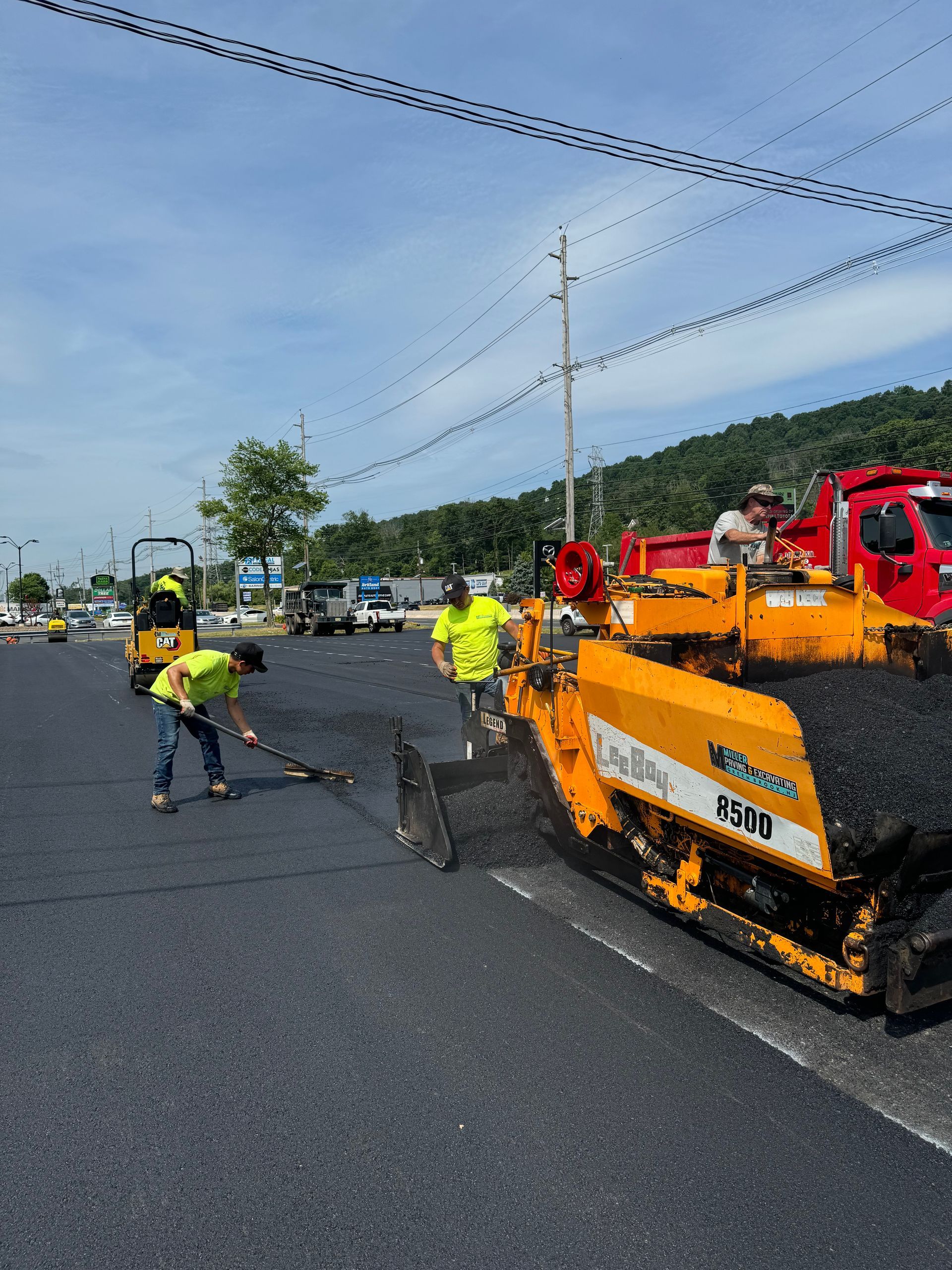 A group of construction workers are working on a road.