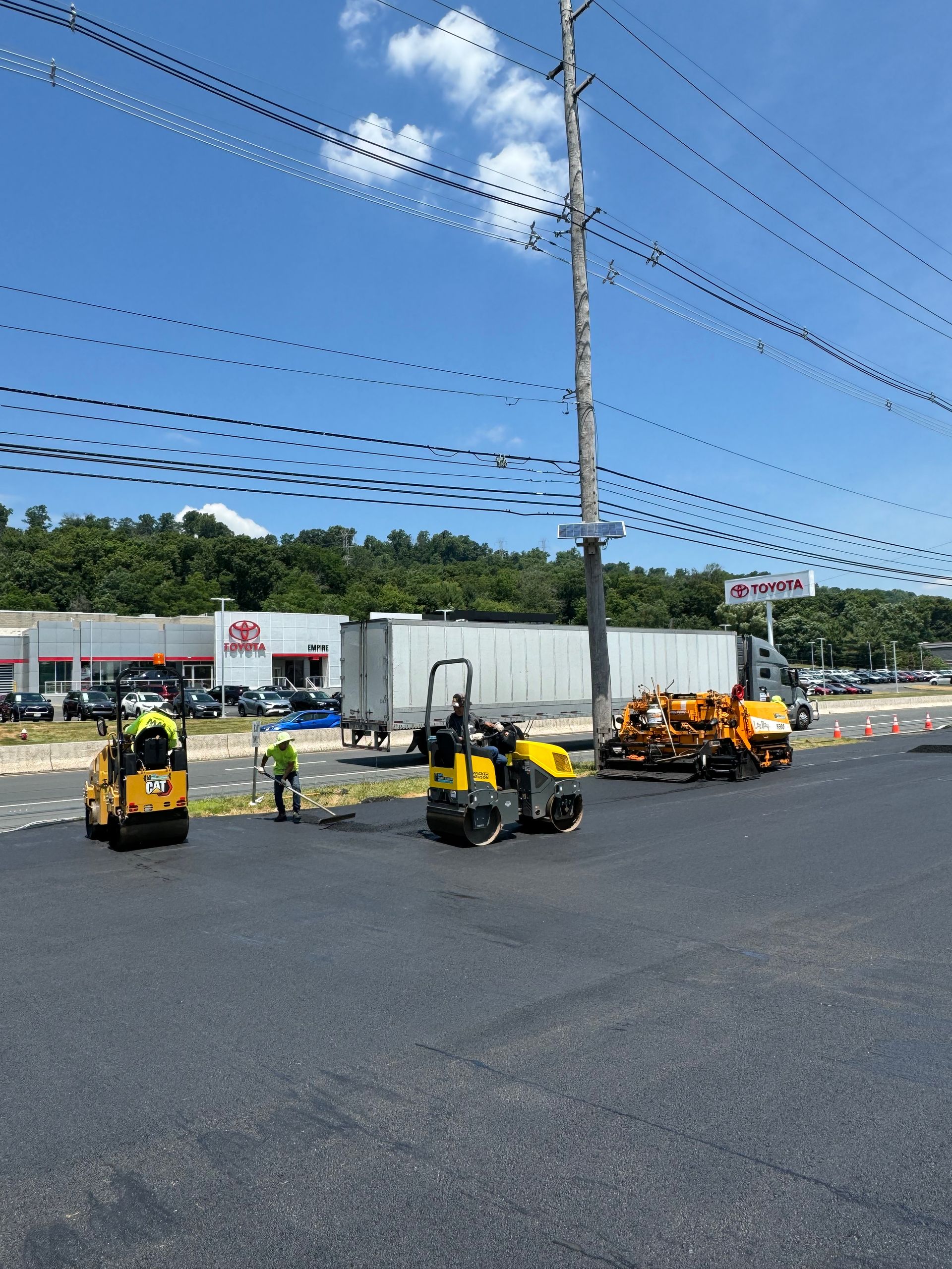 A group of construction workers are working on a road.