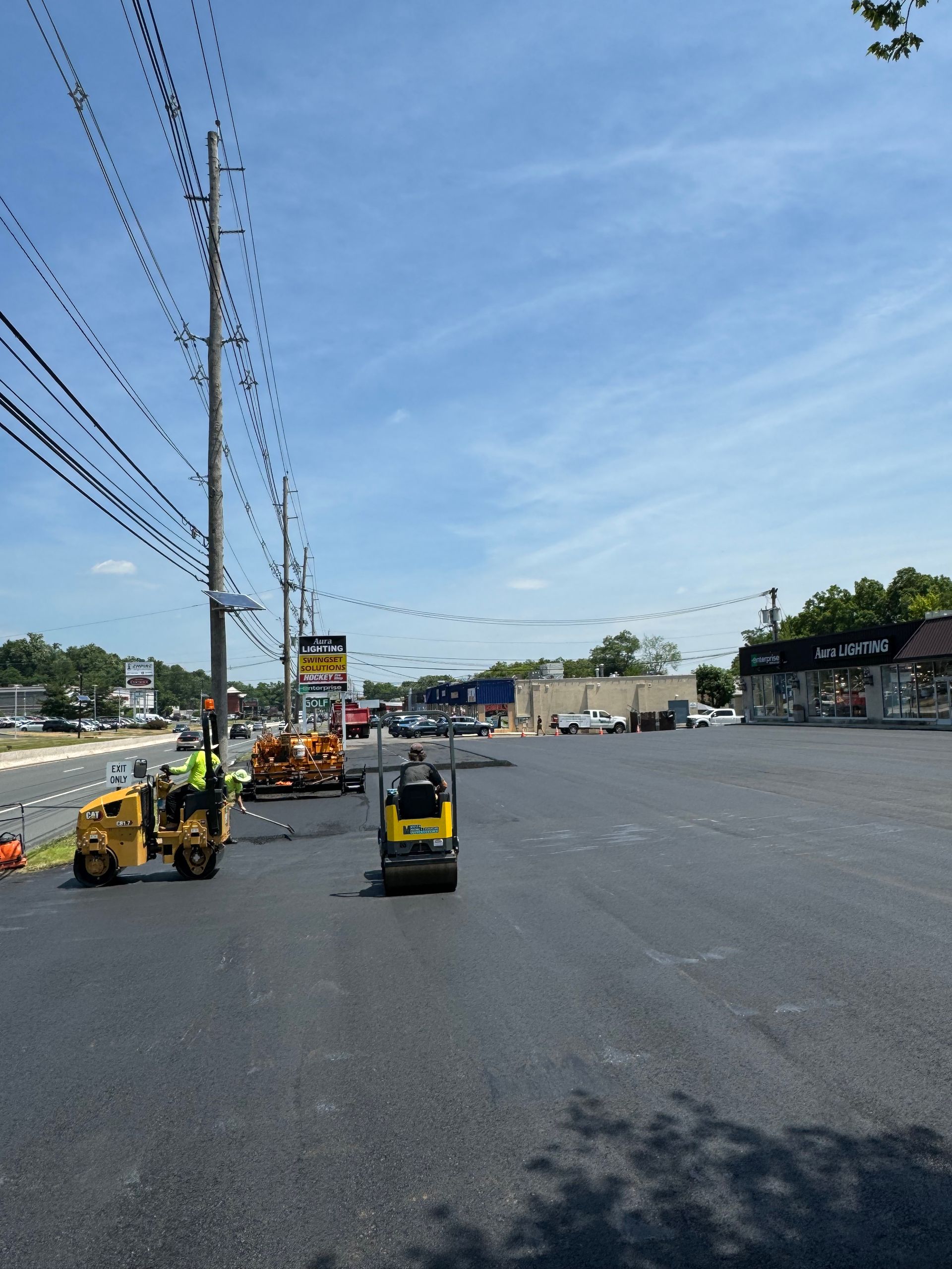 A large empty parking lot with a yellow forklift in the middle