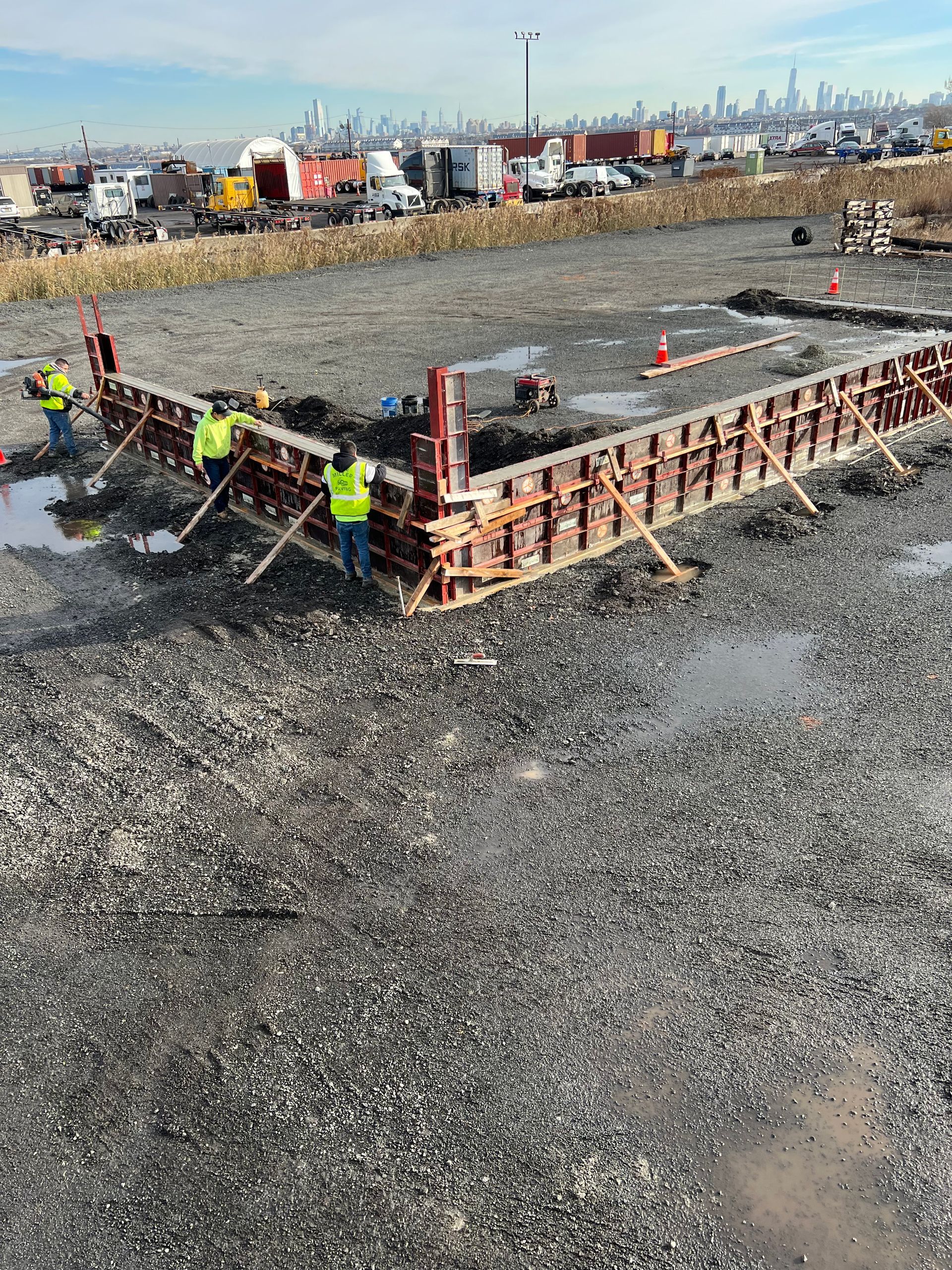 A group of construction workers are working on a large concrete structure.
