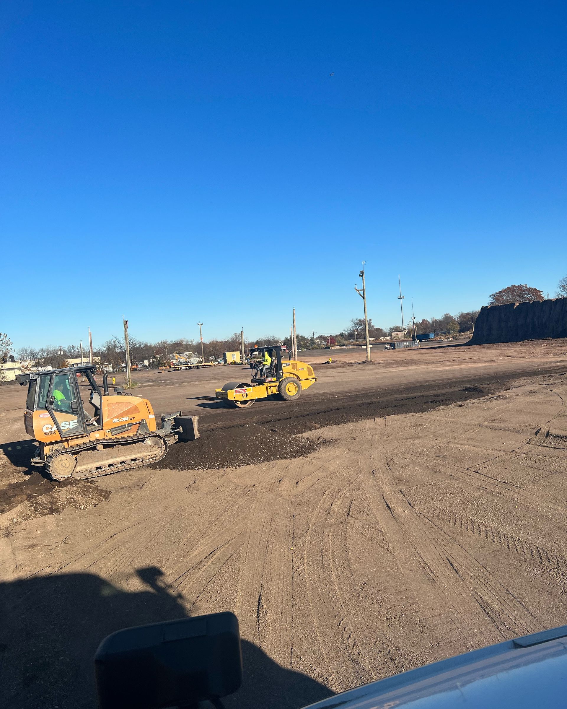 A bulldozer is driving through a dirt field.