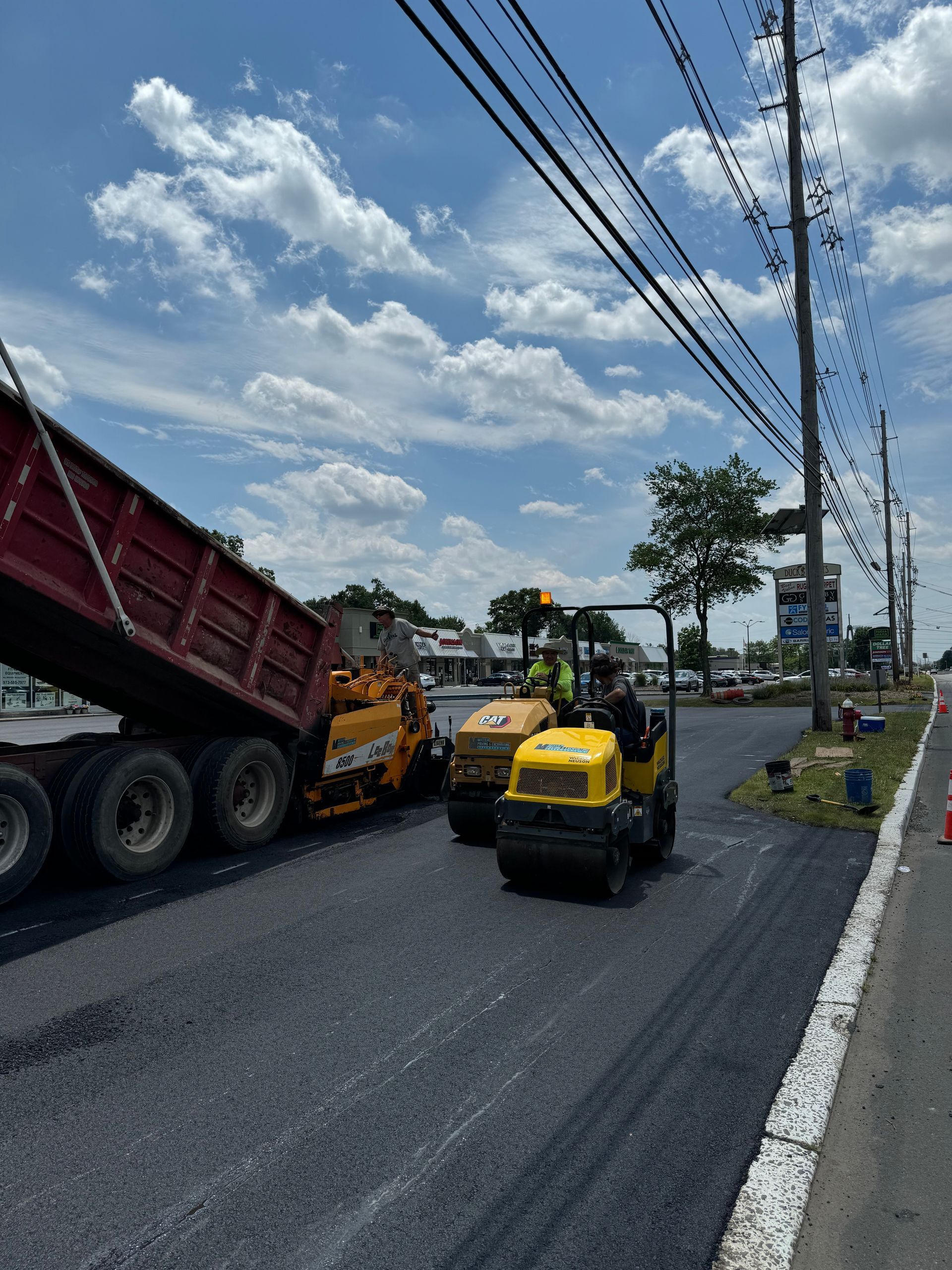 A dump truck is being dumped on the side of the road