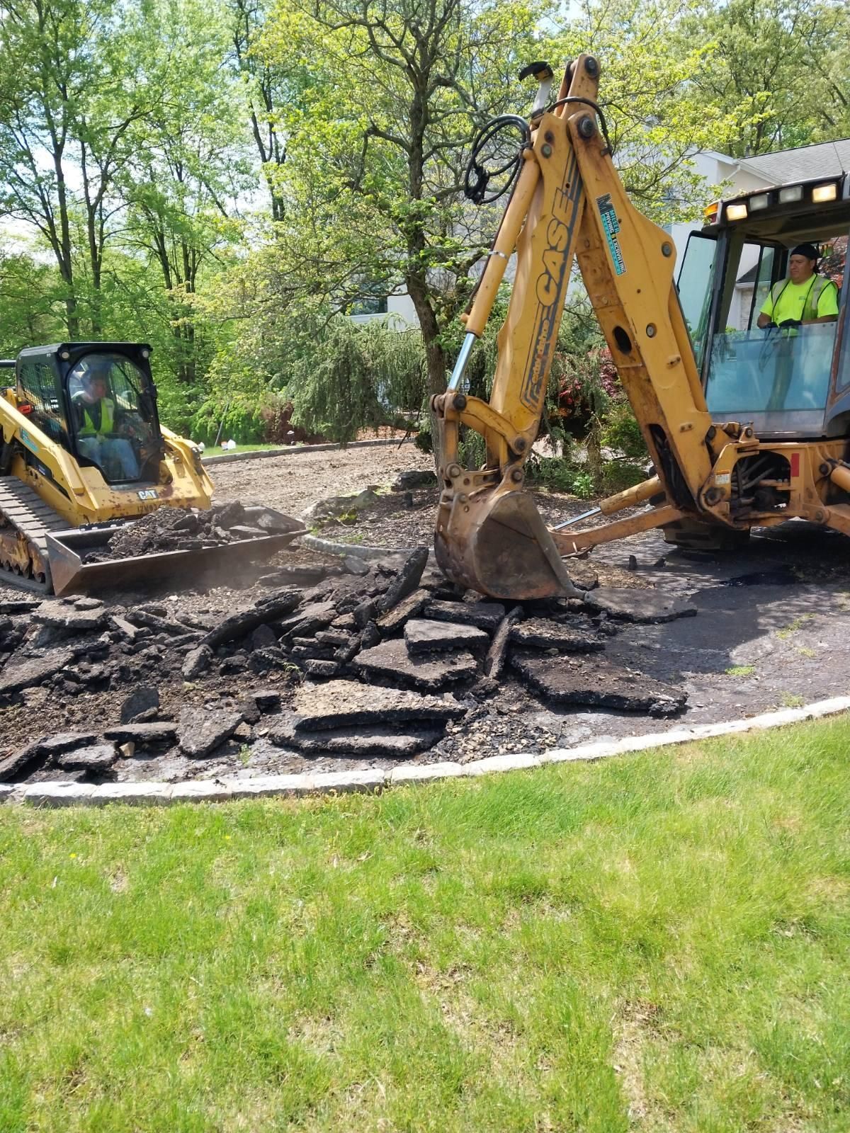 A man is driving a bulldozer on a dirt road.