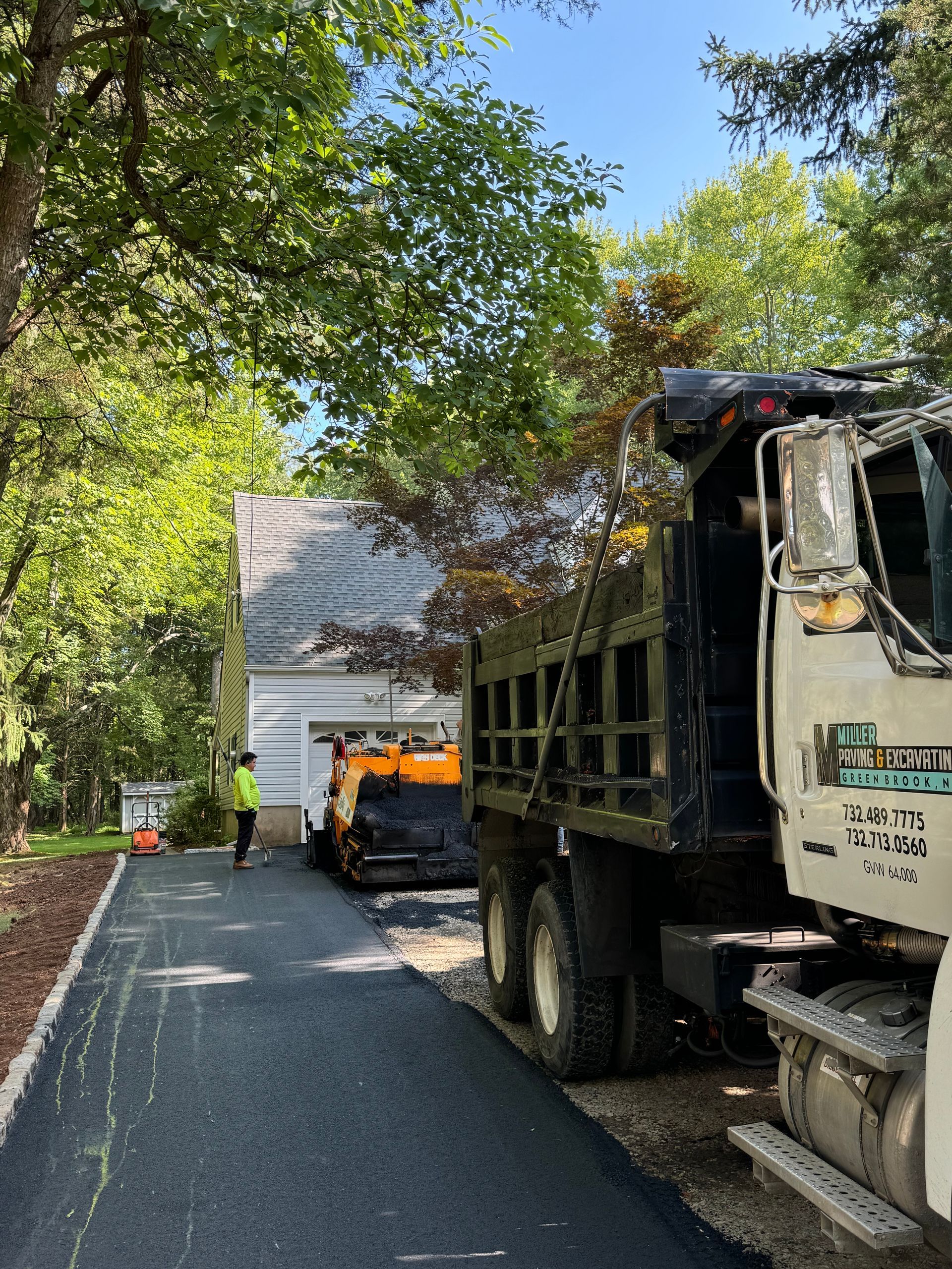 A dump truck is parked on the side of a road.