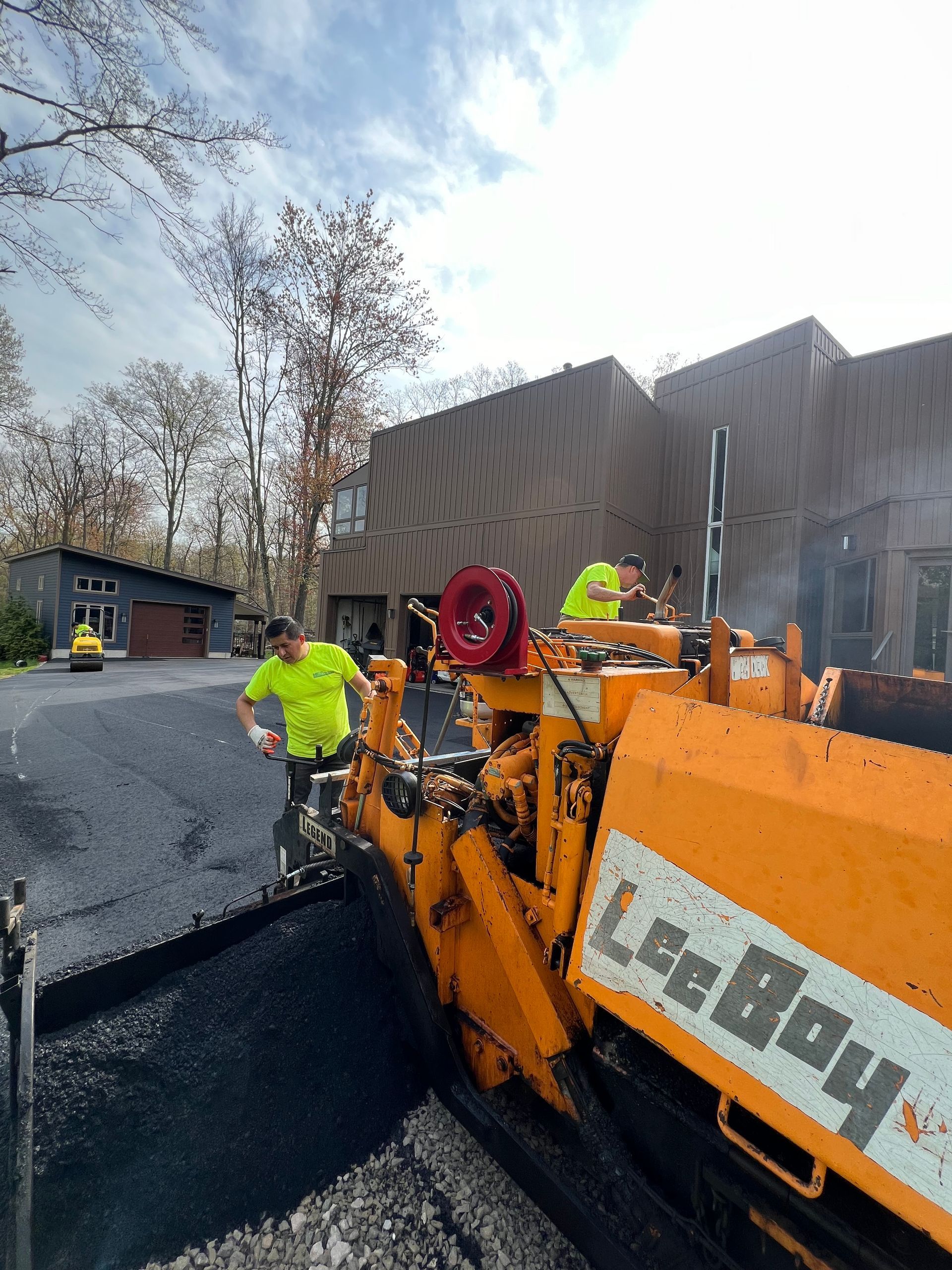A man is standing next to a machine that says lee boy on it.