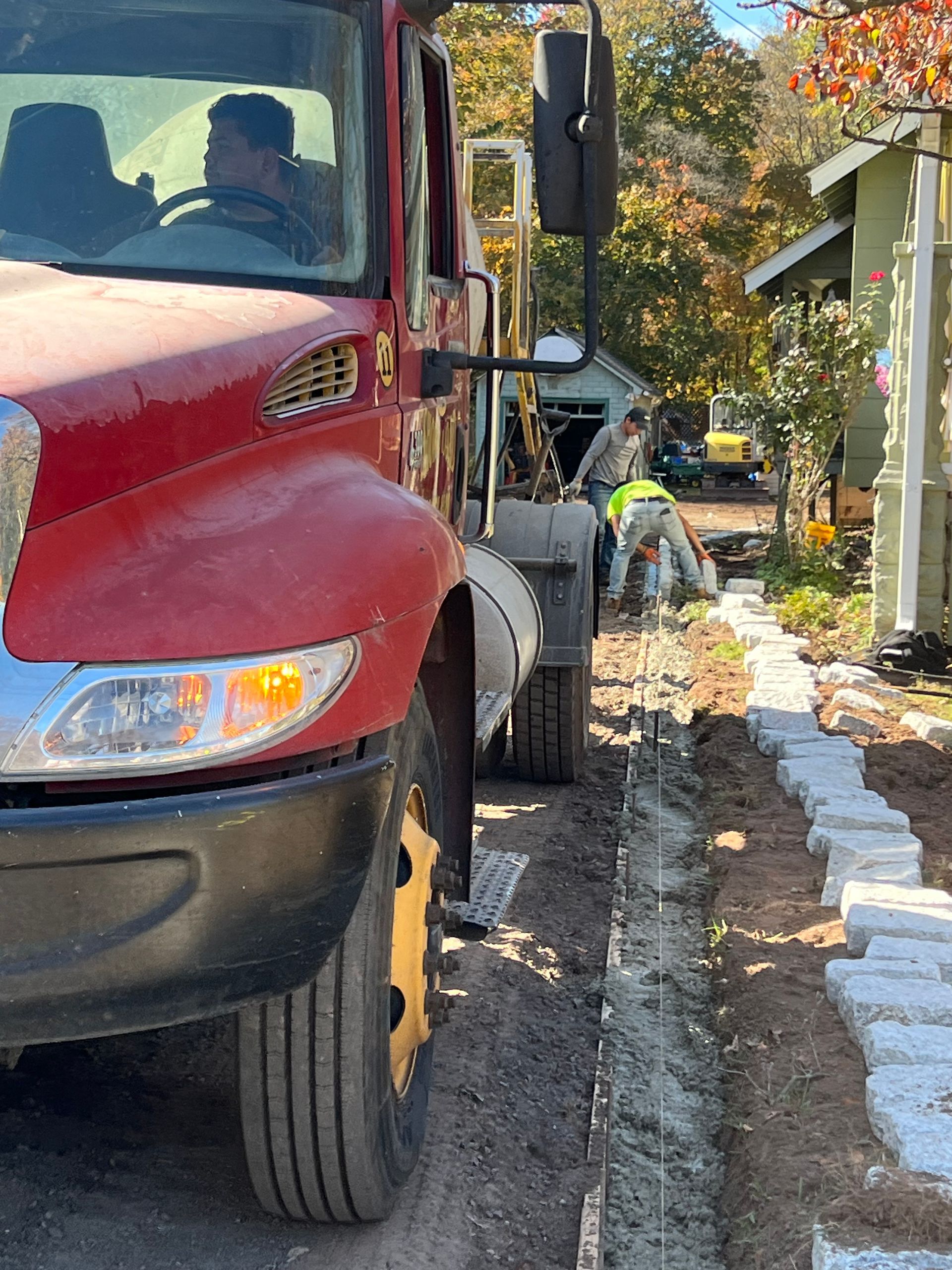 A red truck is parked on the side of the road.