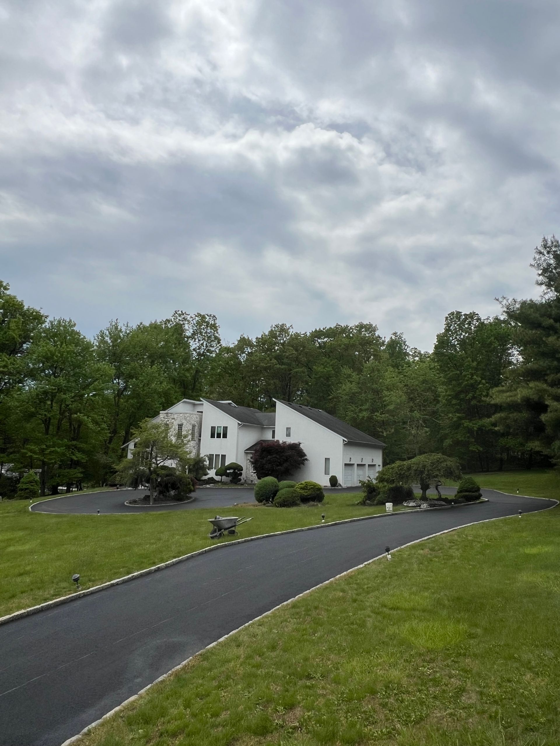 A white house with a driveway leading to it