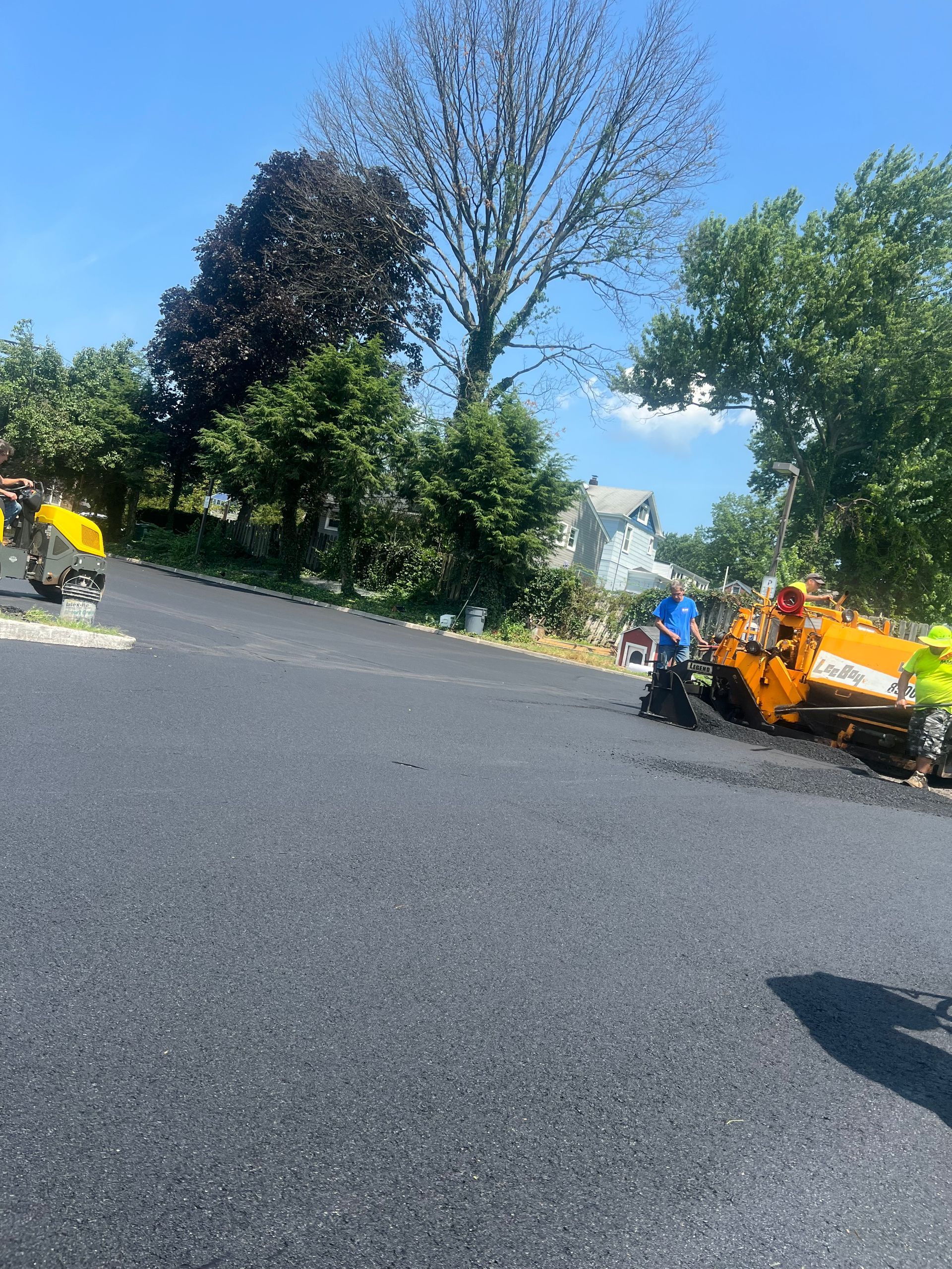 A group of people are working on a road.